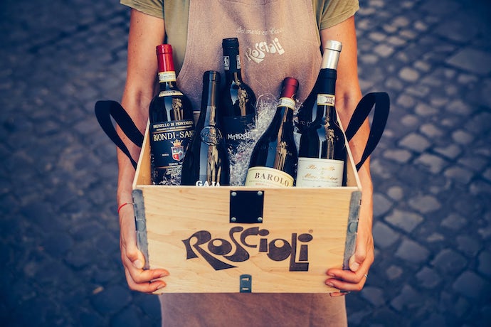 woman holds a Roscioli wine box