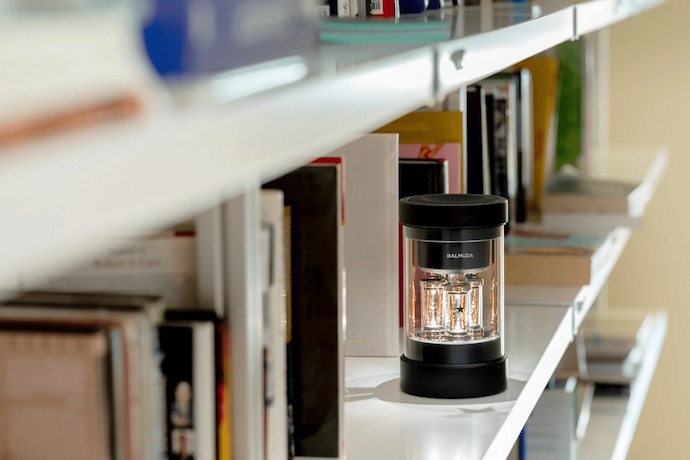 balmuda speaker on a bookshelf